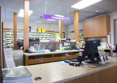 A pharmacy with a counter and a computer.