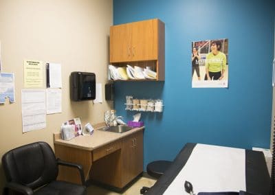 A doctor's office with a desk and a monitor.