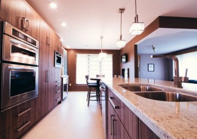 A kitchen with a large counter top and stainless steel appliances.