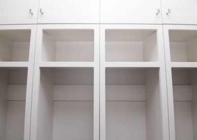 A white closet with shelves and drawers.